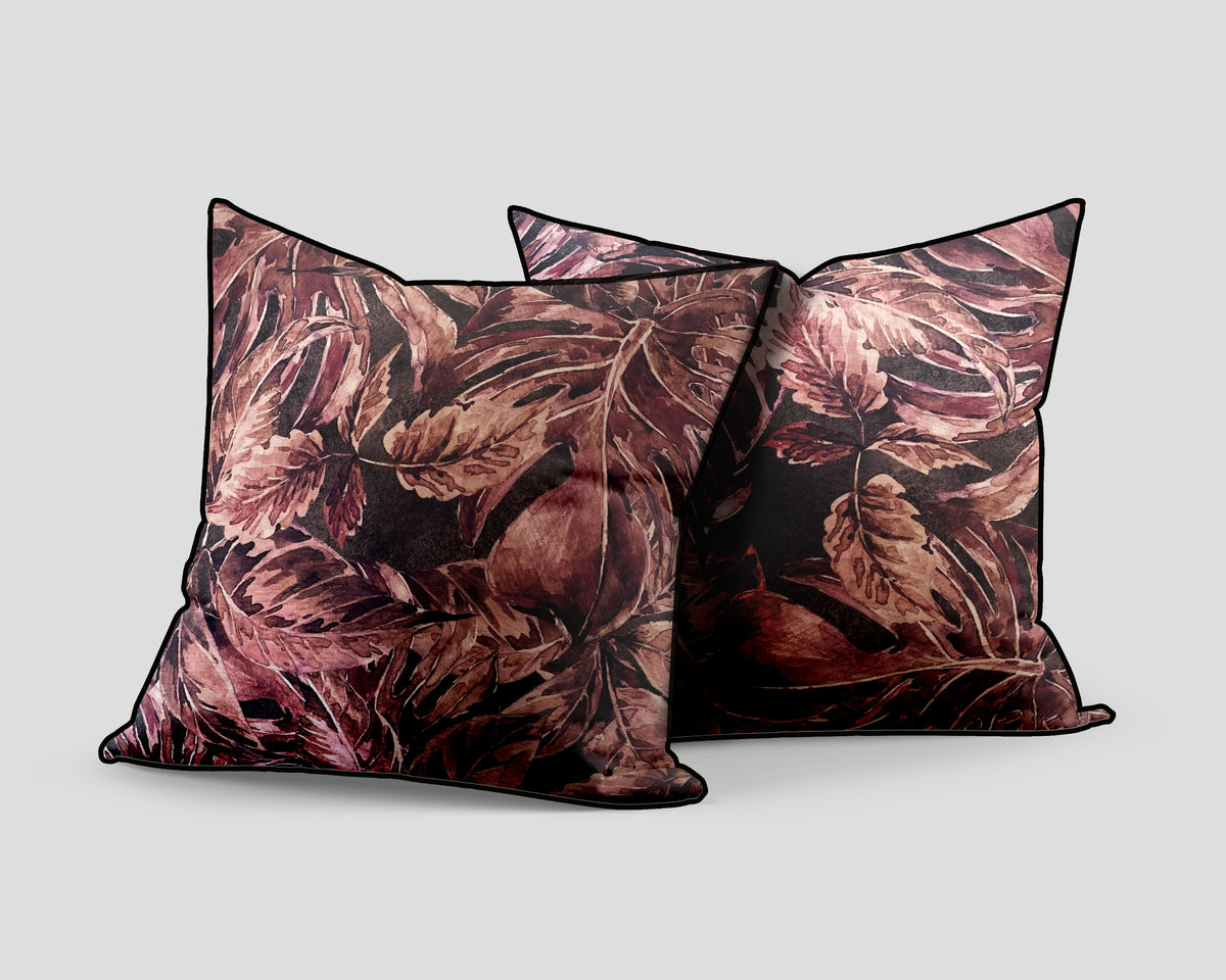 Set of three decorative scatter cushions featuring a rich burgundy, dusty rose, and brown botanical leaf pattern with dark piping, ideal for adding warmth and sophisticated texture to interiors.