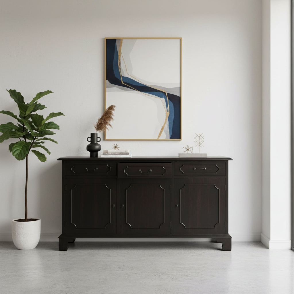 Elegant dark wood sideboard featuring three drawers, three cabinet doors, refined panel detailing, and a classic raised base, styled in a sophisticated modern interior.