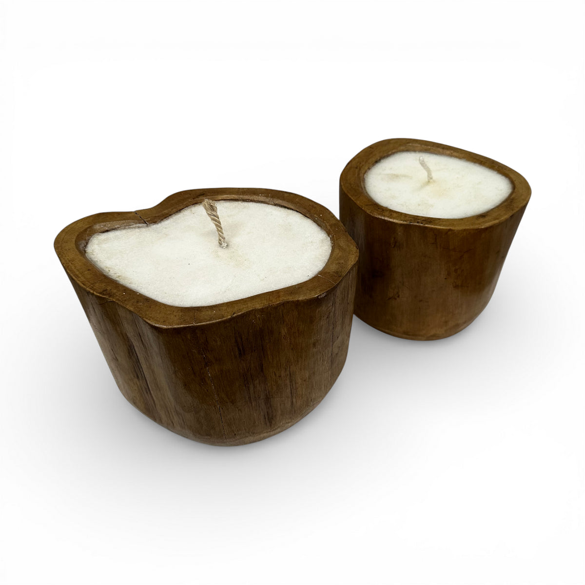 Set of handcrafted candles poured into solid teak wood vessels with organic freeform rims, showcasing the natural grain and warm timber tones of the wood. These rustic-modern candles make elegant decorative accents for coffee tables, dining tables, shelves, boutique hotels, or contemporary interiors.