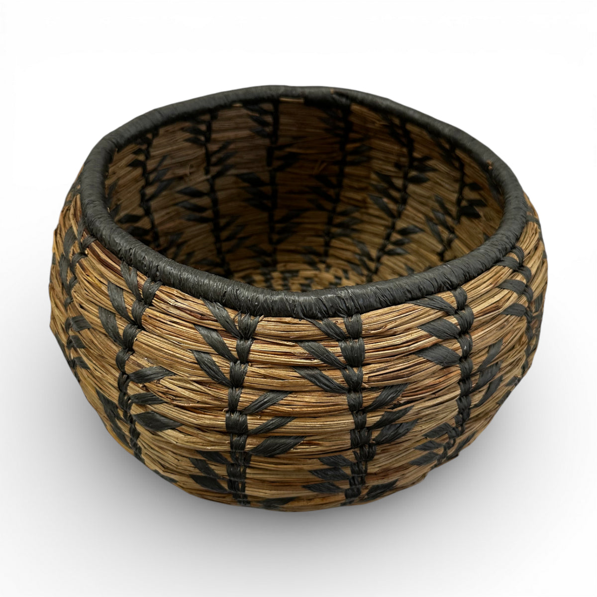 Handwoven decorative basket featuring natural seagrass with a bold black geometric pattern and rounded silhouette, perfect for organising small household items or adding artisanal texture and contemporary bohemian style to shelves, coffee tables, or consoles.