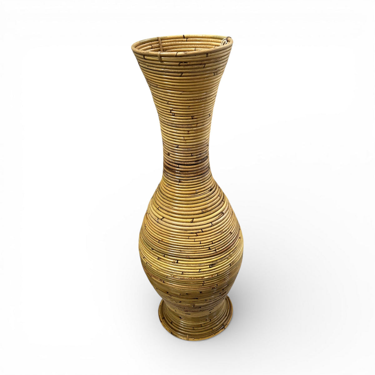 Handwoven natural floor vase with a tall sculptural hourglass silhouette and richly textured woven finish, perfect for displaying decorative branches, pampas grass, or dried botanicals while adding warm organic texture and timeless artisanal elegance to contemporary, coastal, and rustic interiors.