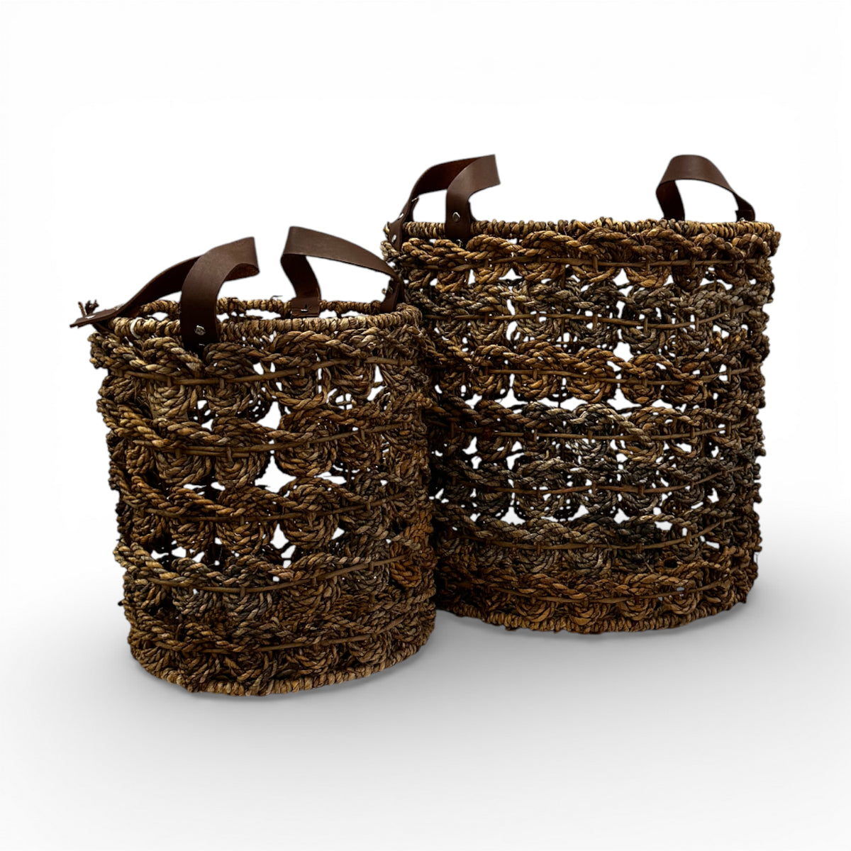 Set of two handwoven open-weave storage baskets with rich natural fibres and genuine leather handles, offering stylish storage for blankets, plants, or everyday essentials while adding organic texture and contemporary artisanal charm to modern, coastal, and rustic interiors.