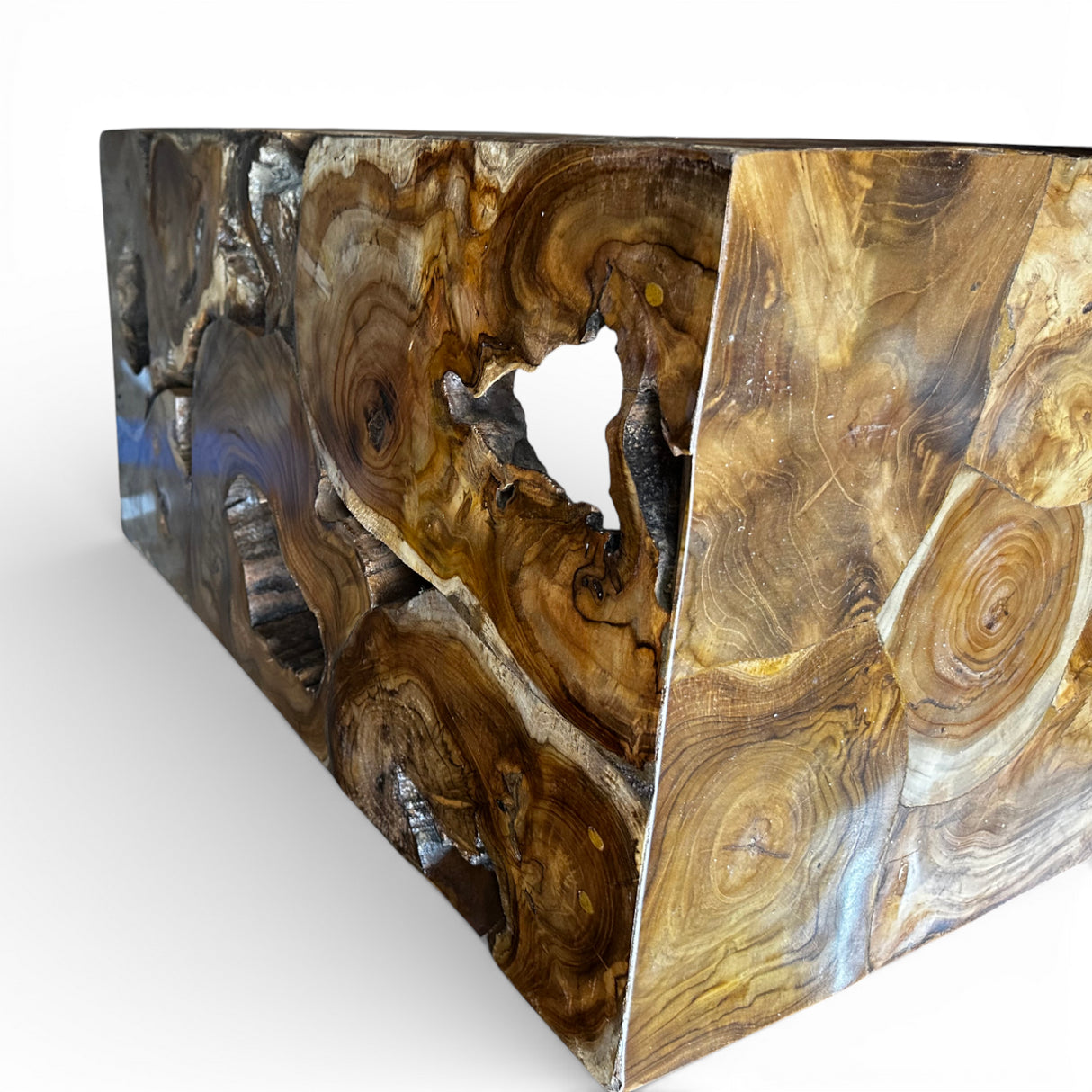 Close-up of a handcrafted reclaimed wood console table featuring a natural live-edge design, striking wood grain patterns, and an organic sculptural cut-out detail that highlights the timber's natural character.