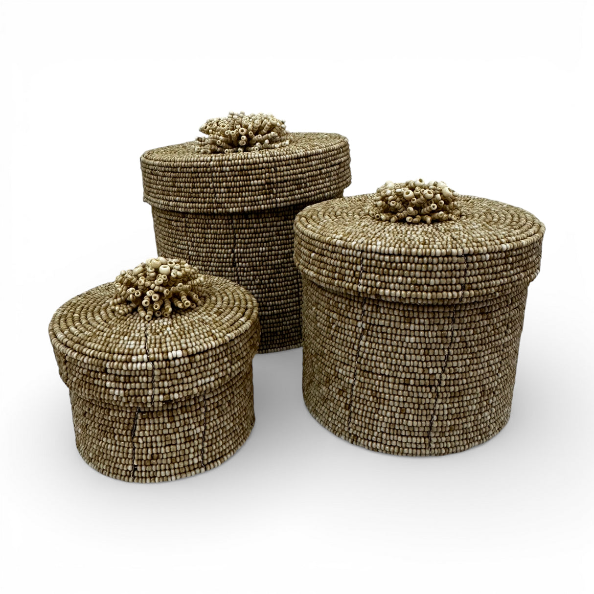 Set of three handcrafted cylindrical storage baskets with natural wooden beads, matching fitted lids, and decorative beaded handles, perfect for elegant storage and adding warm organic texture to living rooms, bedrooms, or bathrooms.