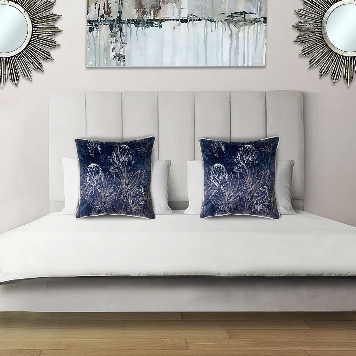 Decorative scatter cushion featuring an elegant protea-inspired botanical pattern in rich navy blue and soft silver tones, perfect for adding sophisticated colour and texture to stylish interiors.