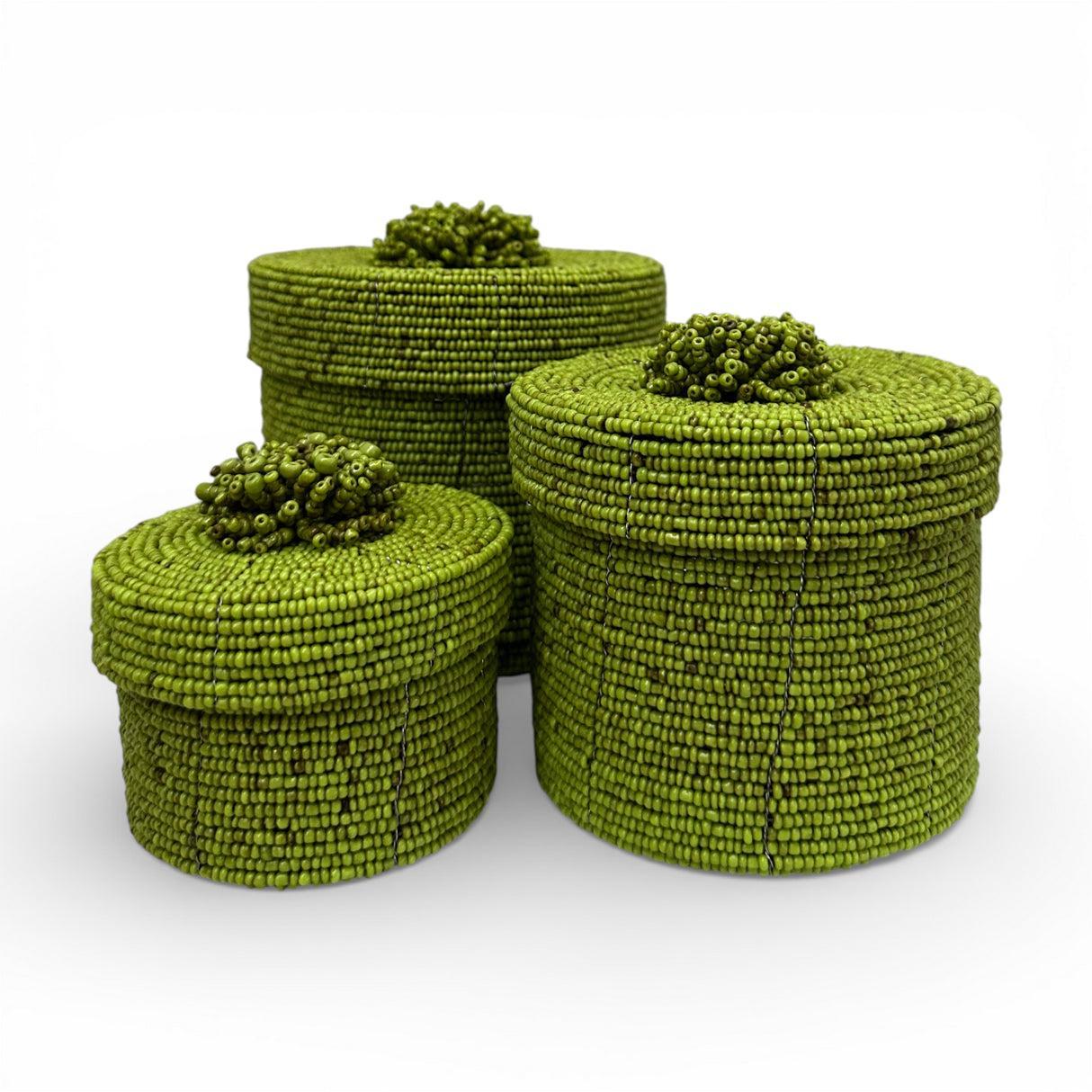 Set of three handcrafted cylindrical storage baskets with olive green wooden beads, matching fitted lids, and decorative beaded handles, perfect for stylish storage and adding vibrant natural texture to living rooms, bedrooms, or bathrooms.