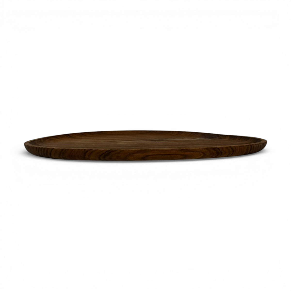 Side profile of a round walnut wooden serving tray with a slim raised edge and rich natural wood grain, showcasing its minimalist handcrafted design for serving and decorative styling.