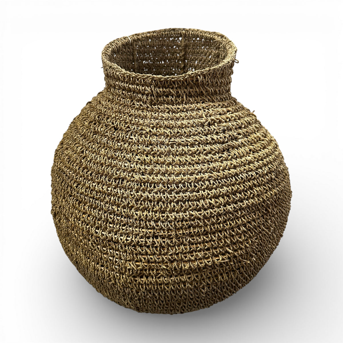 Handcrafted round woven natural fibre basket with a sculptural bulb shape and narrow opening, ideal for adding organic texture to modern interiors.