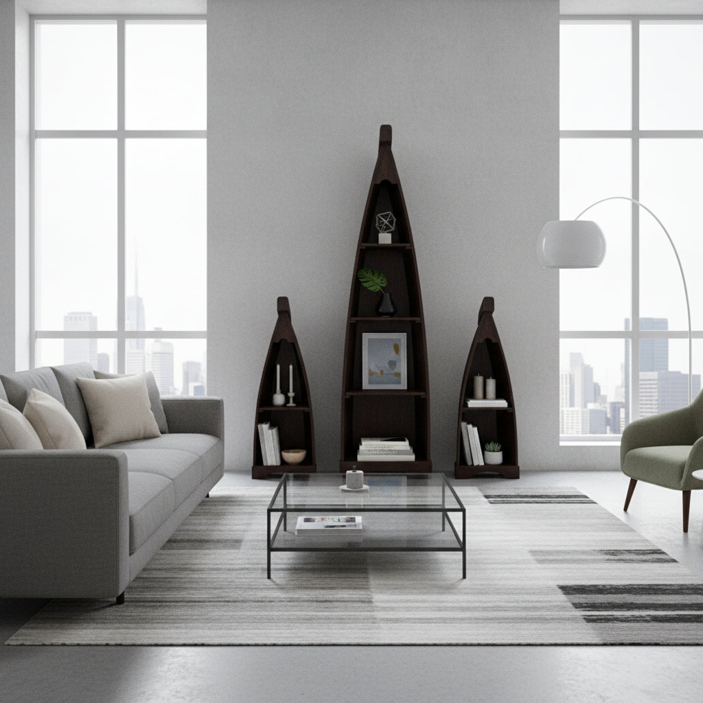 Set of three handcrafted canoe-shaped display shelves in a dark stained wood finish, styled with books, candles, framed art, and decorative accessories in a contemporary living room.