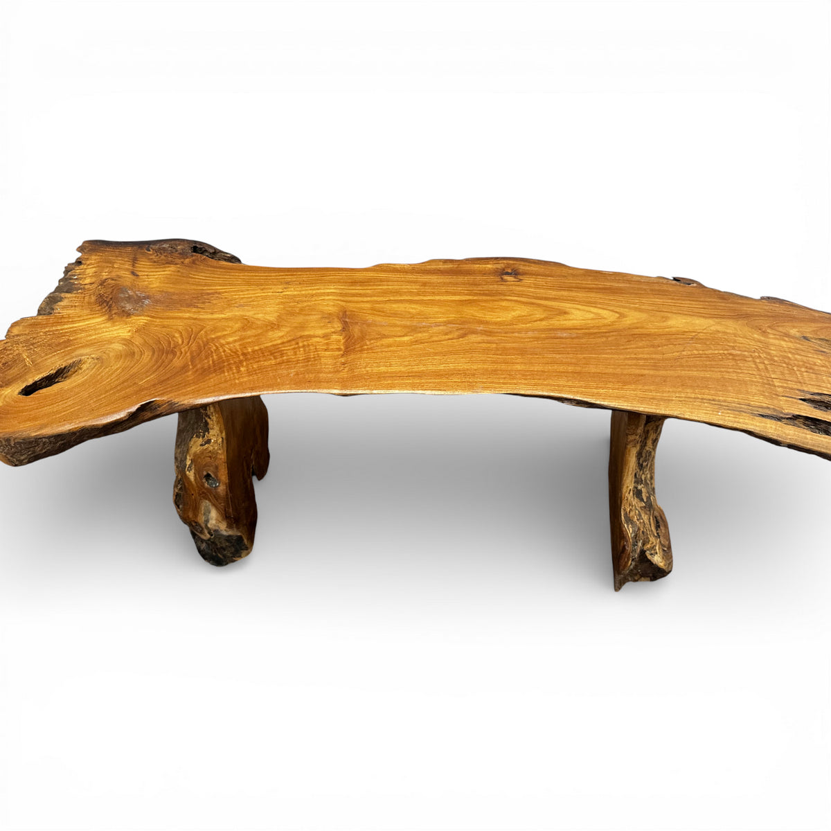 Handcrafted rustic live edge coffee table made from solid natural timber, featuring an organic slab tabletop with sculptural log legs, showcasing rich wood grain and timeless artisan craftsmanship.