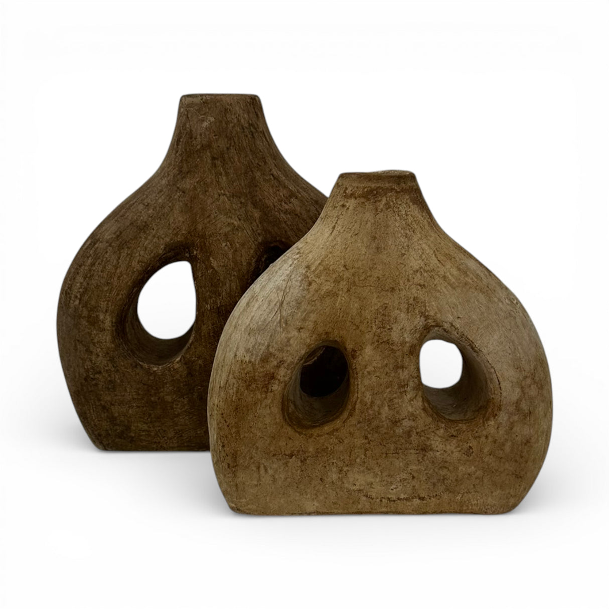 Set of two handcrafted sculptural stoneware vases in complementary warm brown and natural earthy finishes, featuring organic rounded silhouettes with decorative cut-out openings. Contemporary statement décor pieces that add texture, warmth, and artistic character to console tables, shelves, coffee tables, or modern styled interiors.