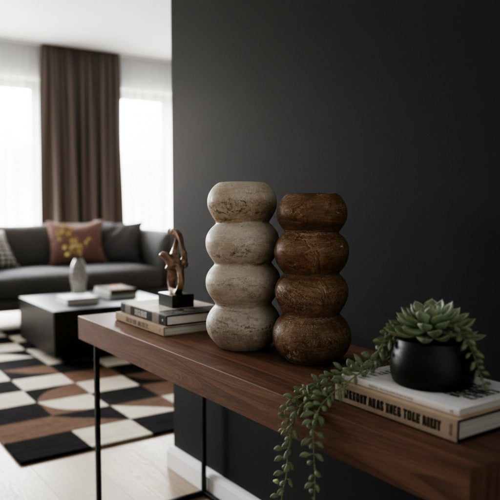 Set of two stacked sculptural decorative vases with rounded segmented silhouettes in natural stone and dark wood finishes. Contemporary statement décor pieces perfect for styling console tables, shelves, or coffee tables with modern organic elegance.