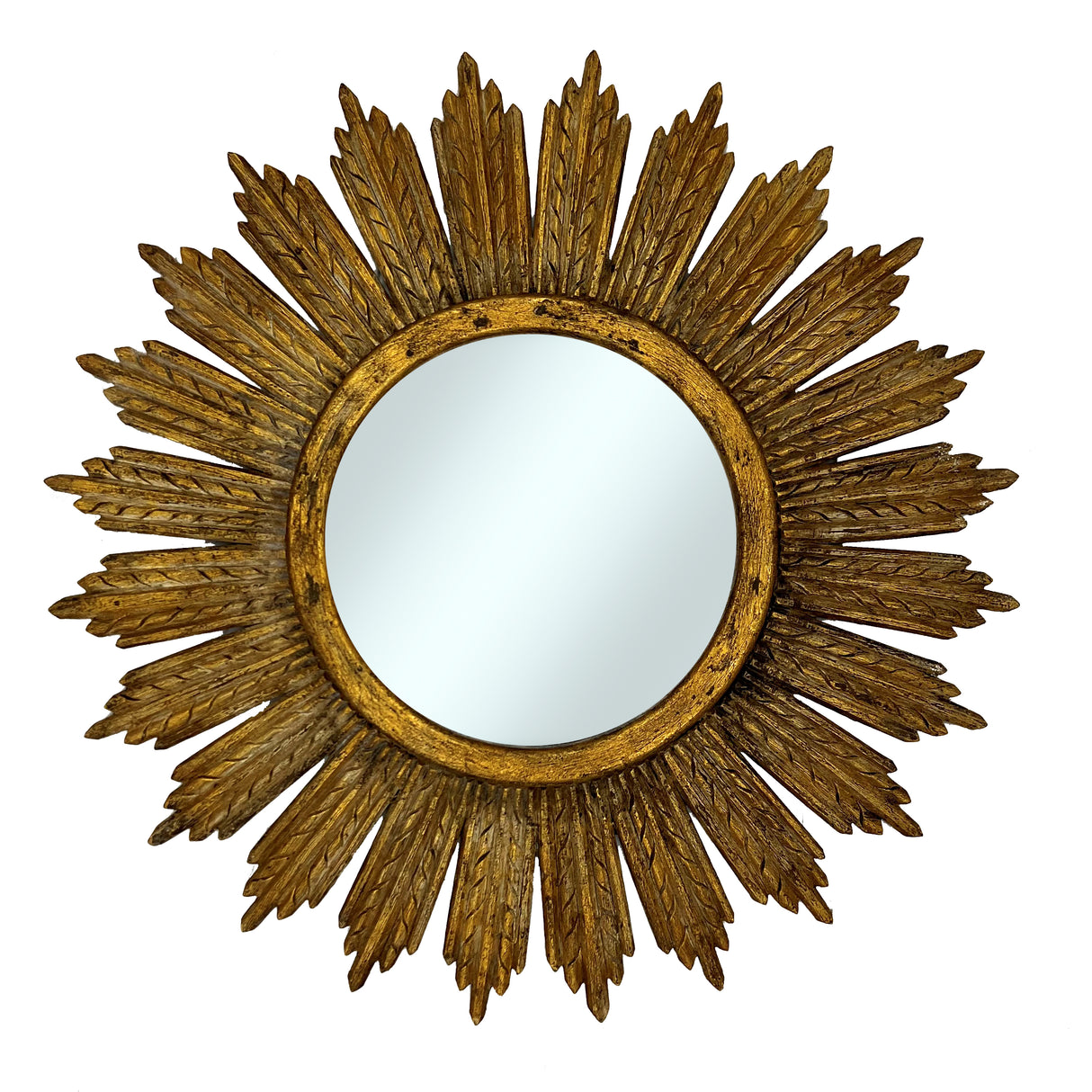 Decorative round wall mirror with an antique gold textured sunburst frame featuring layered leaf-inspired rays and a distressed metallic finish, creating a timeless luxury statement for any interior.