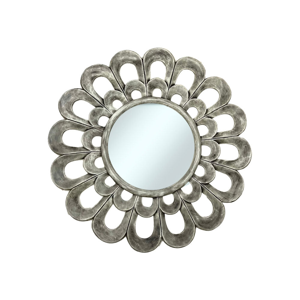 Decorative round wall mirror with a silver petal-inspired frame featuring layered openwork loops and a distressed metallic finish, creating an elegant floral statement for any interior.