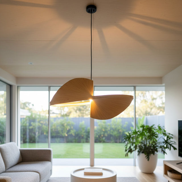 Abstract sculptural pendant light featuring two intersecting leaf-inspired panels with a brushed metallic finish and integrated LED illumination. A striking statement ceiling light for modern, luxury, contemporary, and designer interiors.