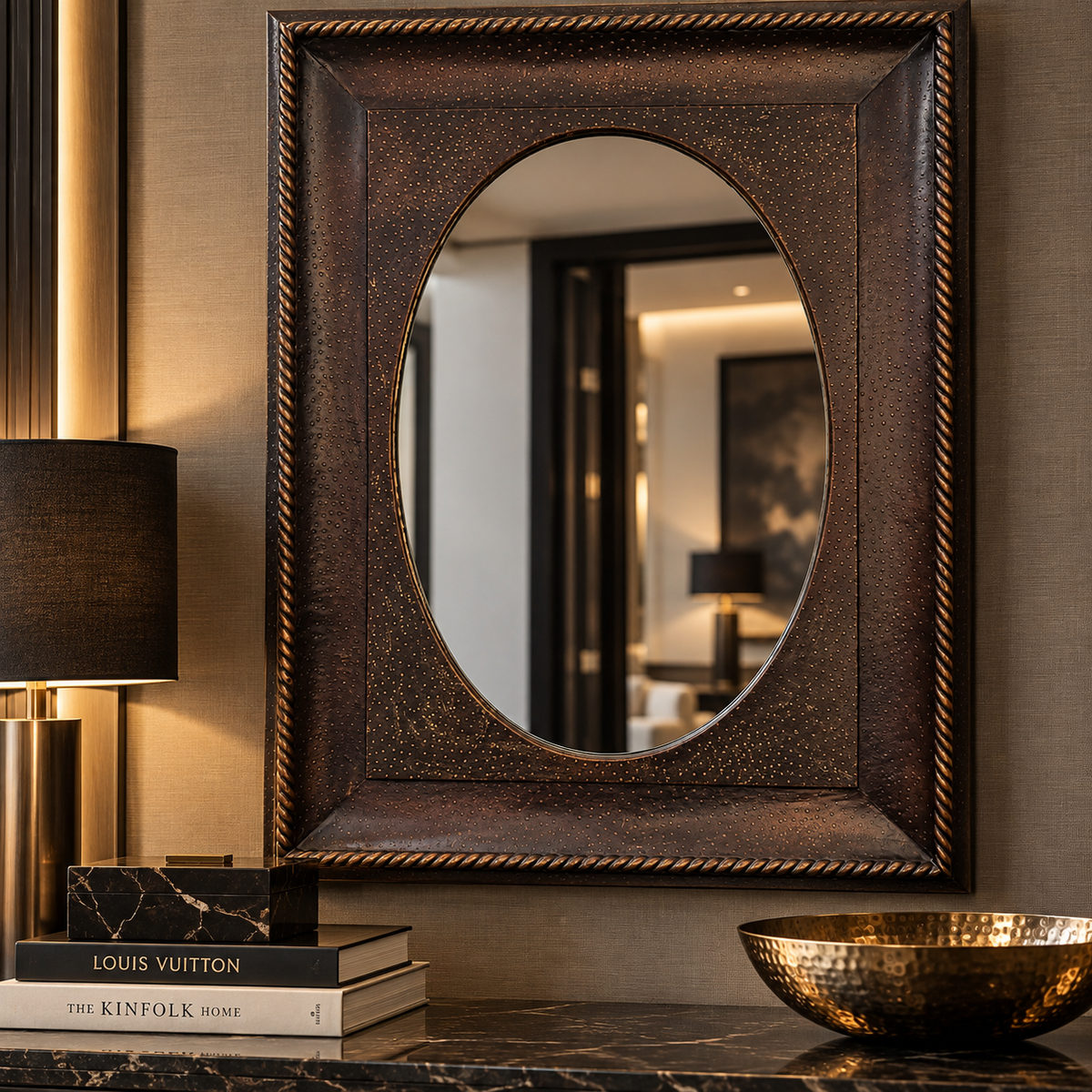 Oval mirror set within a wide rectangular bronze frame with a speckled finish and twisted rope border.