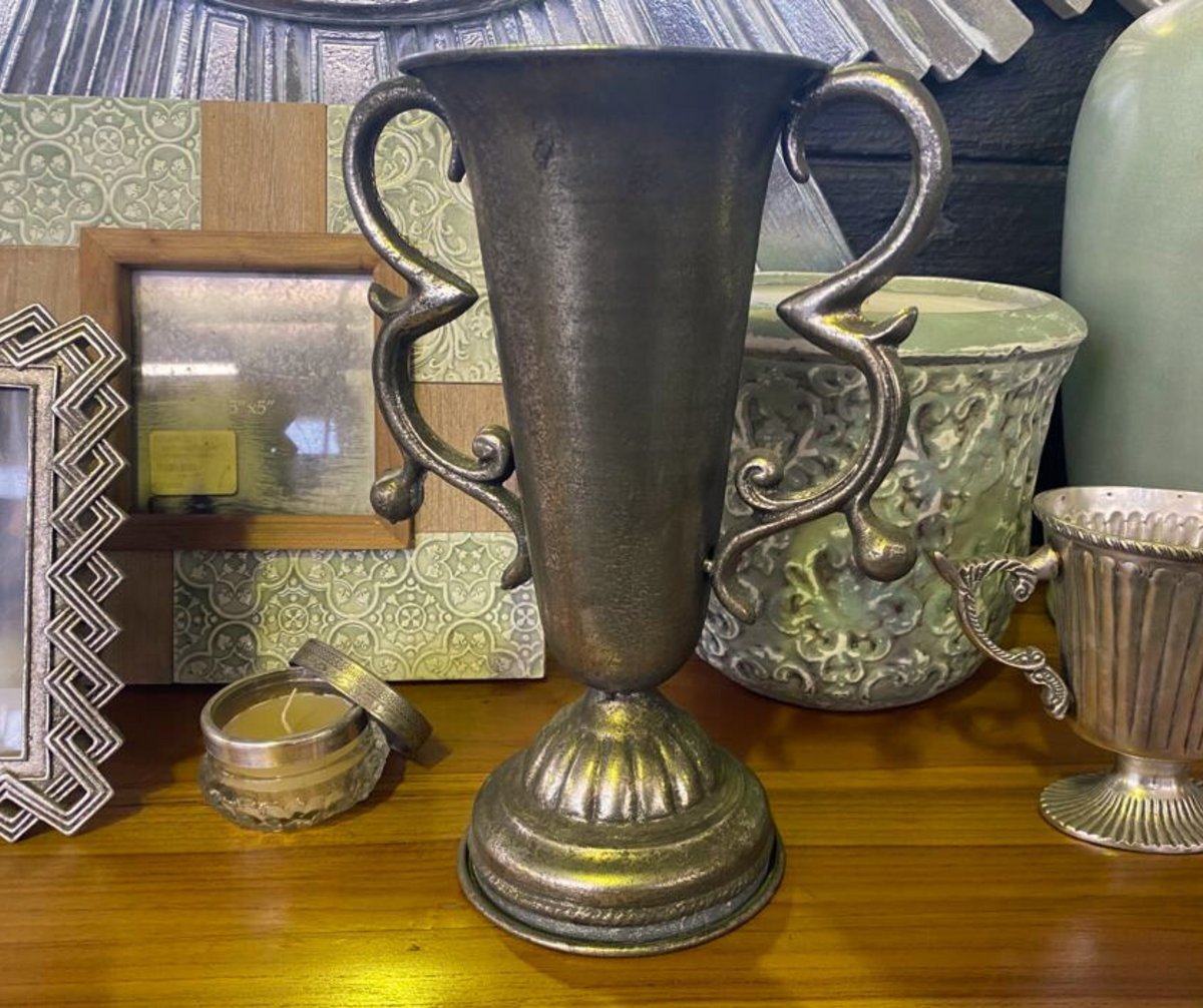 Elegant antique pewter decorative urn vase with ornate scroll handles, a fluted pedestal base, and a distressed metallic finish, perfect for classic, rustic, and luxury interior décor.