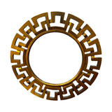 Round decorative wall mirror featuring a brushed gold geometric frame with a bold Greek key-inspired design, creating a contemporary luxury statement piece.