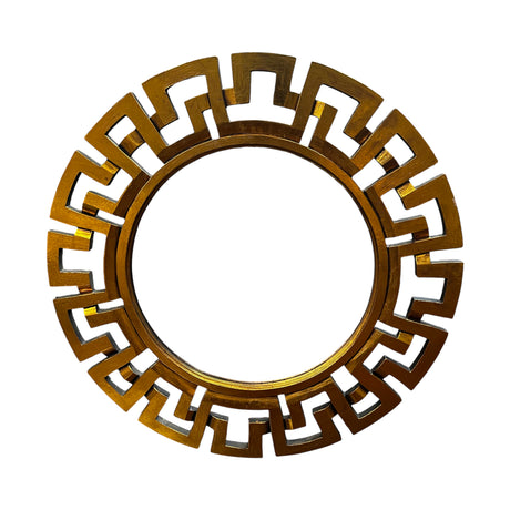 Round decorative wall mirror featuring a brushed gold geometric frame with a bold Greek key-inspired design, creating a contemporary luxury statement piece.