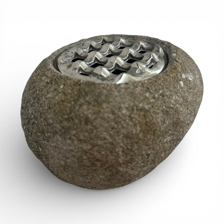 Decorative beige marble potpourri bowl featuring a polished natural stone finish and a decorative silver metal lattice lid, styled on a contemporary coffee table. A timeless accent piece that adds warmth and elegance to modern living rooms, consoles, shelves, and luxury interiors.