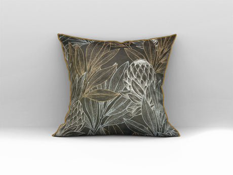 Decorative scatter cushion featuring elegant protea flowers and botanical leaves in black, charcoal, gold, and soft silver tones with coordinating gold piping.