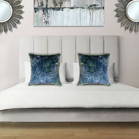 Decorative blue scatter cushion featuring an elegant protea and botanical leaf pattern with contrasting green piping, perfect for adding colour and texture to stylish interiors.