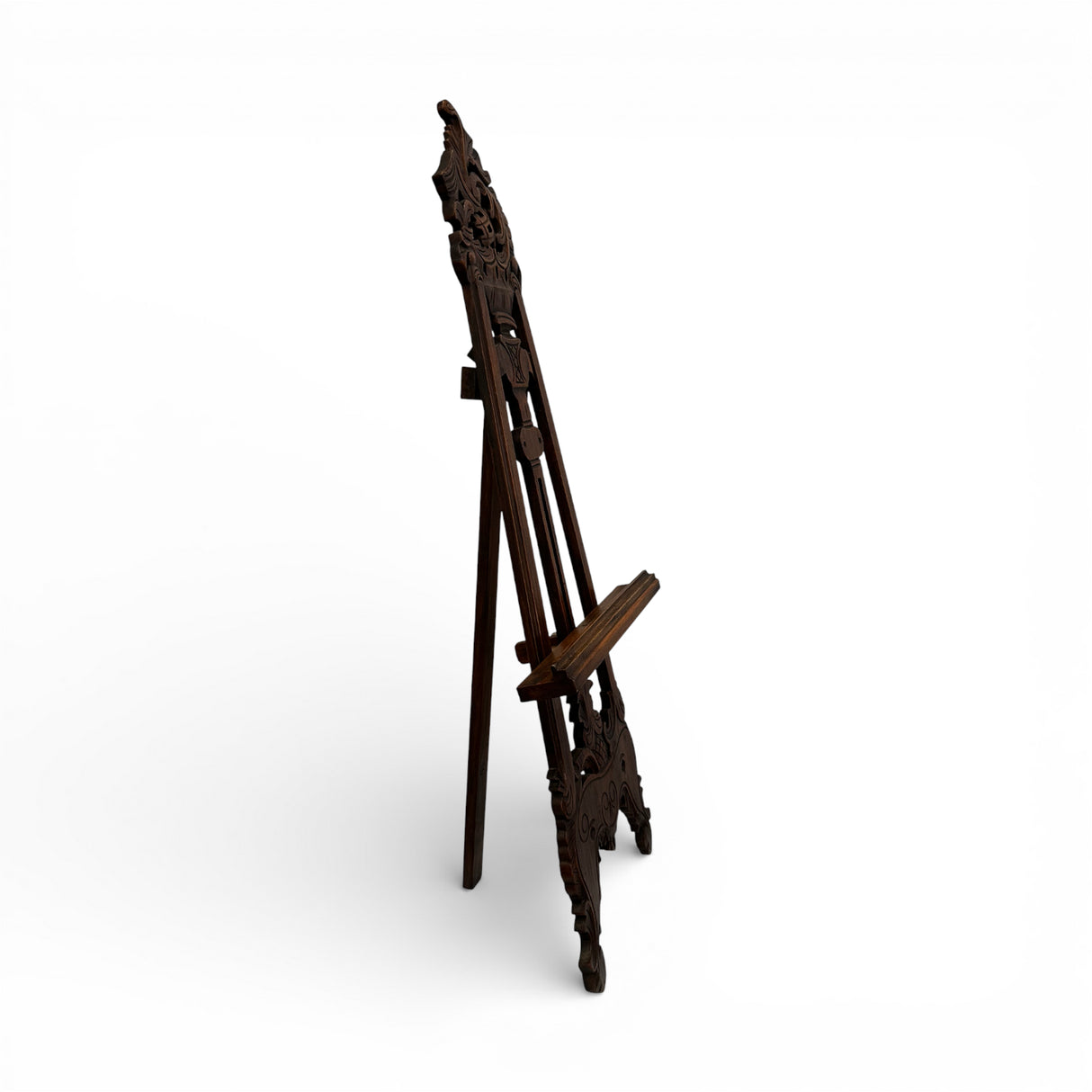 Traditional carved wooden display easel in a rich dark wood finish, featuring intricate ornamental detailing and an adjustable support, perfect for displaying artwork, mirrors, wedding signage, menus, or decorative pieces.
