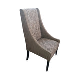 Modern high-back dining chair upholstered in textured grey fabric with contrasting patterned seat and backrest panels. Featuring gently curved wingback sides and sleek dark wooden legs, this elegant chair is ideal for dining rooms, restaurants, boutique hotels, or contemporary interiors.