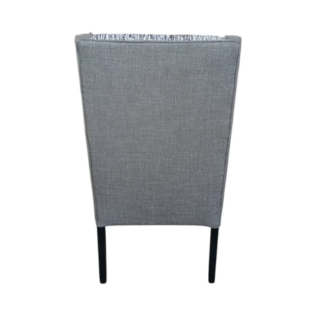 Modern high-back dining chair upholstered in textured grey fabric with contrasting patterned seat and backrest panels. Featuring gently curved wingback sides and sleek dark wooden legs, this elegant chair is ideal for dining rooms, restaurants, boutique hotels, or contemporary interiors.