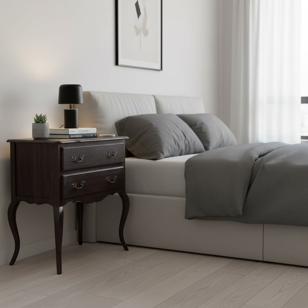 Modern bedroom with a bed and nightstand featuring a lamp and books.