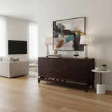 Elegant dark wood sideboard featuring geometric line detailing across the cabinet fronts, a raised base, and tapered wooden legs, styled in a sophisticated contemporary interior.