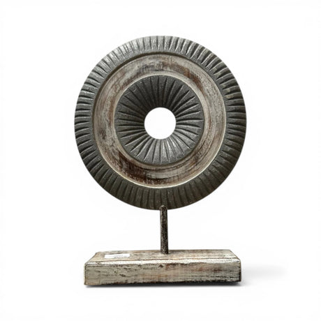 Decorative dark carved wooden ring sculpture mounted on a sturdy stand, featuring detailed radial carving and a distressed charcoal and natural wood finish. A contemporary tabletop accent that adds texture and sophistication to modern, industrial, Scandinavian, and rustic home décor.
