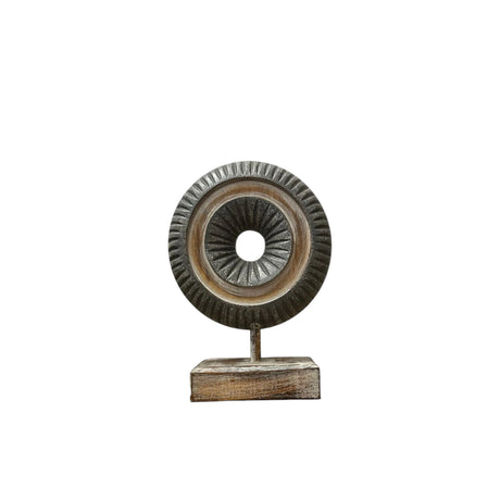 Decorative dark carved wooden ring sculpture mounted on a sturdy stand, featuring detailed radial carving and a distressed charcoal and natural wood finish. A contemporary tabletop accent that adds texture and sophistication to modern, industrial, Scandinavian, and rustic home décor.