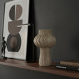 Fluted stoneware sculptural vase with a textured natural finish, featuring a rounded bulb-shaped body, narrow neck, and vertical ribbed detailing. A contemporary decorative vase that adds organic texture and timeless elegance to shelves, consoles, or coffee tables.