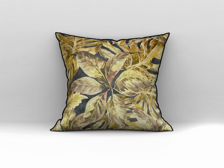 Decorative scatter cushion featuring a rich tropical leaf pattern in gold, mustard, olive, and deep charcoal tones with contrasting dark piping.