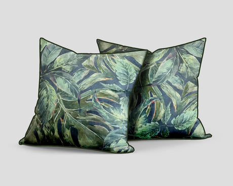 Set of three decorative scatter cushions featuring a lush tropical leaf pattern in layered green, sage, and deep blue tones with coordinating dark green piping.