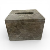 Elegant square tissue box cover crafted from grey marble with natural veining and a polished finish. Features a discreet top opening for tissues, making it a sophisticated accessory for bathrooms, bedrooms, living rooms, or office spaces.