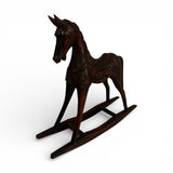 Hand-carved dark wood rocking horse sculpture featuring intricate artisan detailing and a rich polished finish, perfect as a timeless decorative accent for consoles, shelves, coffee tables, or classic and contemporary interiors.