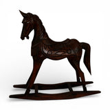 Hand-carved dark wood rocking horse sculpture featuring intricate artisan detailing and a rich polished finish, perfect as a timeless decorative accent for consoles, shelves, coffee tables, or classic and contemporary interiors.