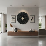 Round handcrafted Juju wall décor featuring layered black feathers with a contrasting white centre, creating a bold and luxurious statement piece. Perfect for living rooms, bedrooms, entryways, boutique hotels, or contemporary interiors seeking dramatic texture and elegance.