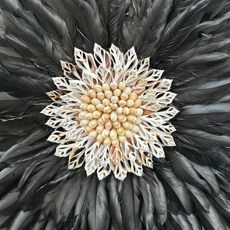 Decorative item with black feathers and a central beige flower-like design