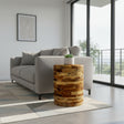 Handcrafted cylindrical side table crafted from solid teak wood, showcasing layered natural timber tones and distinctive wood grain in a clean, contemporary silhouette. This versatile accent table is ideal for living rooms, bedrooms, boutique hotels, lodges, or modern rustic interiors.