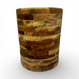 Handcrafted drum-shaped side table crafted from solid teak wood, featuring a smooth cylindrical silhouette that showcases the rich natural grain and warm timber tones in a distinctive patchwork design. Perfect as an accent table, bedside table, or decorative piece for living rooms, bedrooms, boutique hotels, lodges, or contemporary rustic interiors.