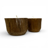 Set of handcrafted candles poured into solid teak wood vessels, showcasing the natural grain, rich timber tones, and organic shape of the wood. These rustic-modern candles add warmth and natural elegance to coffee tables, shelves, dining tables, boutique hotels, or contemporary interiors.