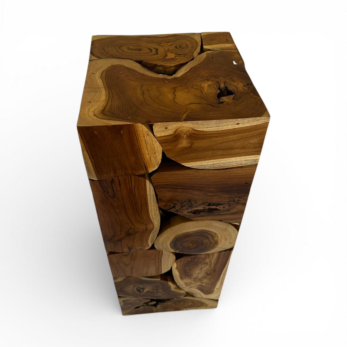 Handcrafted display pedestal made from solid teak wood blocks, featuring a striking patchwork design that showcases the natural grain, knots, and warm timber tones of each piece. Ideal for displaying sculptures, vases, plants, or decorative accessories in living rooms, entryways, galleries, boutique hotels, or contemporary rustic interiors.