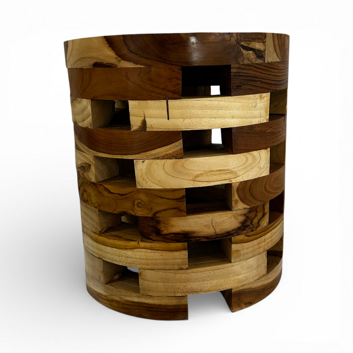 Handcrafted cylindrical accent table crafted from solid teak wood, featuring a unique open-block design with integrated storage compartments that showcase the natural grain and warm timber tones. A functional statement piece perfect as a side table, bedside table, or decorative accent for living rooms, bedrooms, boutique hotels, lodges, or contemporary rustic interiors.