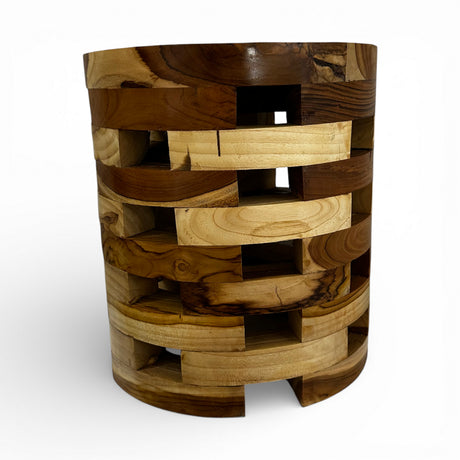 Handcrafted cylindrical accent table crafted from solid teak wood, featuring a unique open-block design with integrated storage compartments that showcase the natural grain and warm timber tones. A functional statement piece perfect as a side table, bedside table, or decorative accent for living rooms, bedrooms, boutique hotels, lodges, or contemporary rustic interiors.