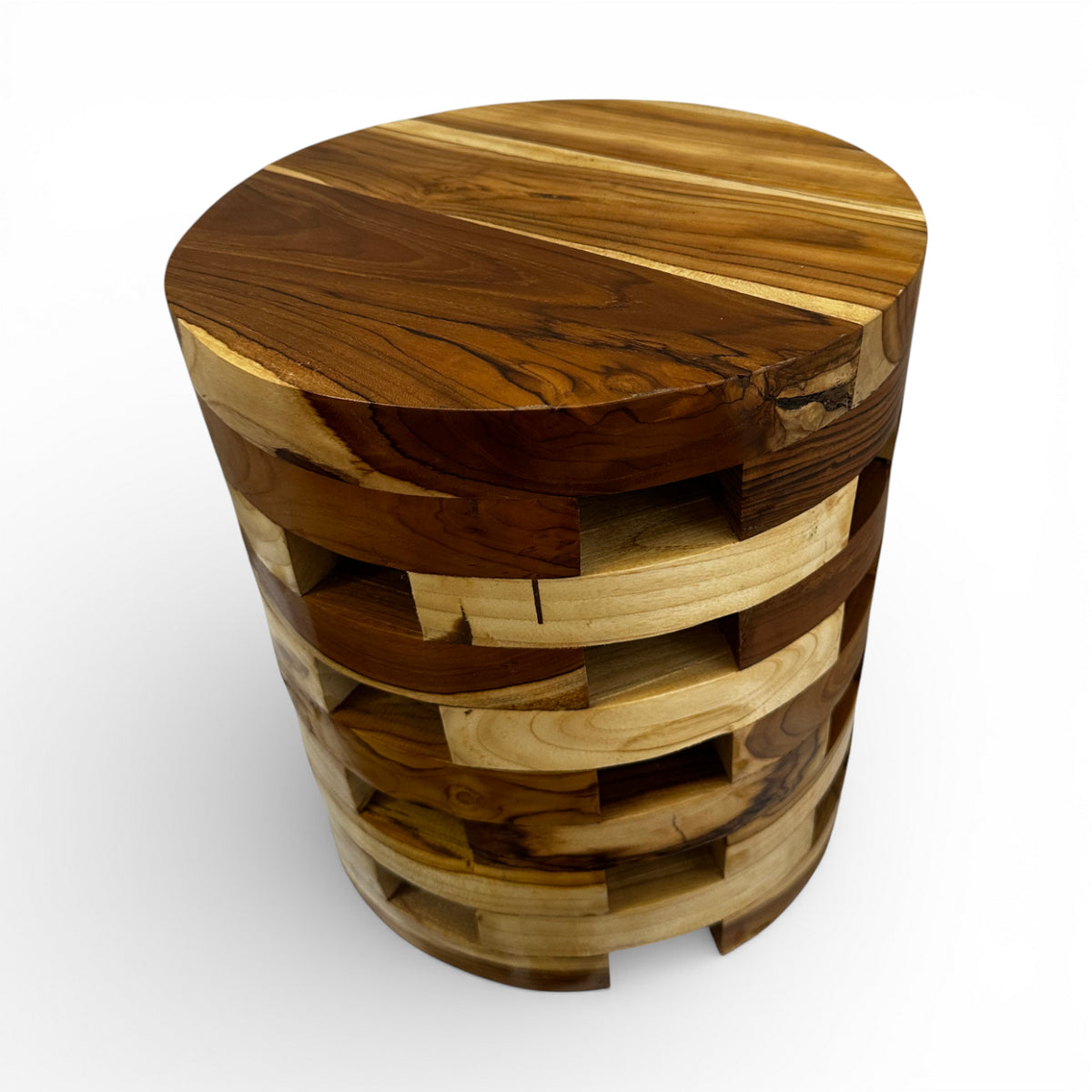 Handcrafted cylindrical accent table crafted from solid teak wood, featuring a unique open-block design with integrated storage compartments that showcase the natural grain and warm timber tones. A functional statement piece perfect as a side table, bedside table, or decorative accent for living rooms, bedrooms, boutique hotels, lodges, or contemporary rustic interiors.