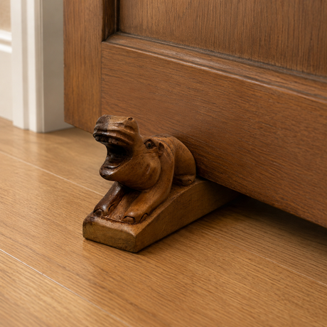Handcrafted wooden hippopotamus door stop with an open-mouth design and rich natural finish. This functional decorative door wedge adds a playful African-inspired touch to modern, rustic, safari, or farmhouse home interiors.