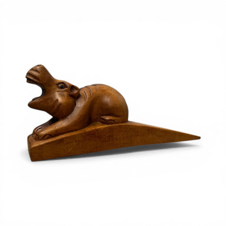 Handcrafted wooden hippopotamus door stop with an open-mouth design and rich natural finish. This functional decorative door wedge adds a playful African-inspired touch to modern, rustic, safari, or farmhouse home interiors.
